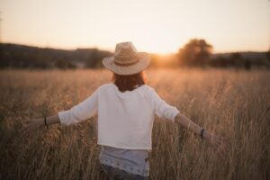 Christian woman walking, reflecting and embracing peace, symbolizing walking in freedom from lies that steal her joy